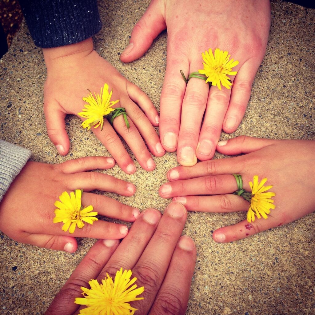 What is financial Stability? Family fingers on the floor, aligning together, with rings in form of sunflowers showing togetherness in making financial decisions.