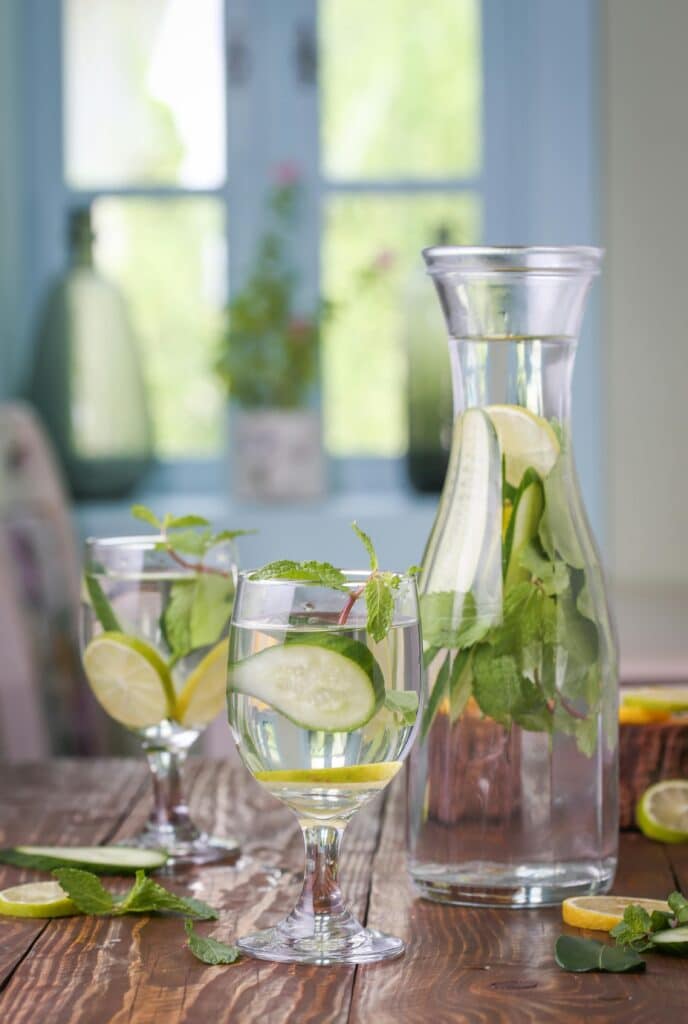 Cucumber, Lemon and Mint infused water in a transparent water and cup.