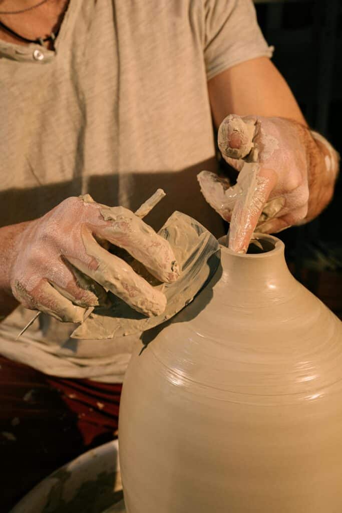 Personal experience and Knowledge, the potter  working on a new design of clay pot.