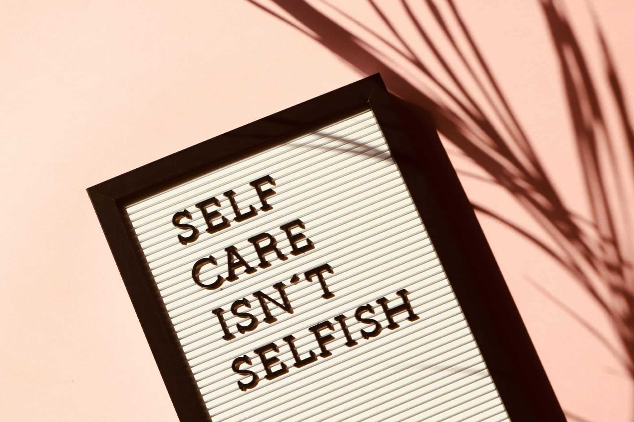 Personal Experience and Knowledge.  A board with a writing -Self care isn't selfish.