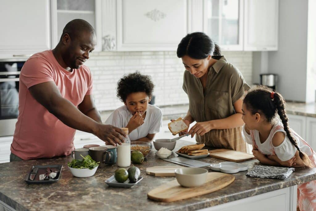 A family making a sandwich breakfast together.