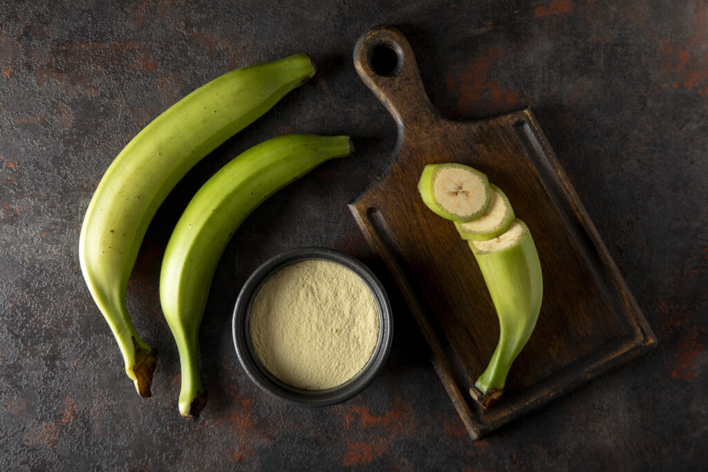 Plantain flour made from the plantains in black bowl.