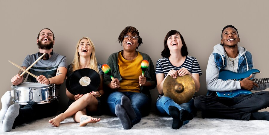 A group of friends play and enjoy their music time together.