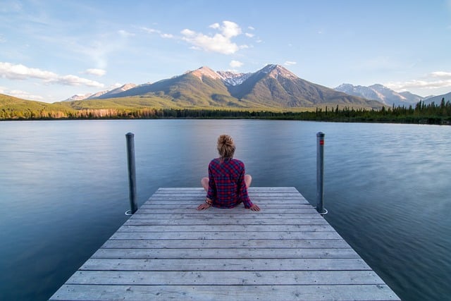 A lady seated at the riverside alone and feeling frustrated