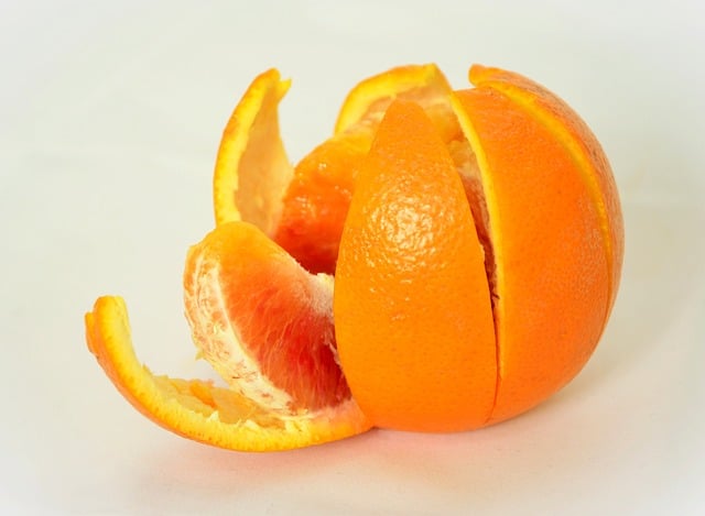 Orange separating its fruit from its peel.